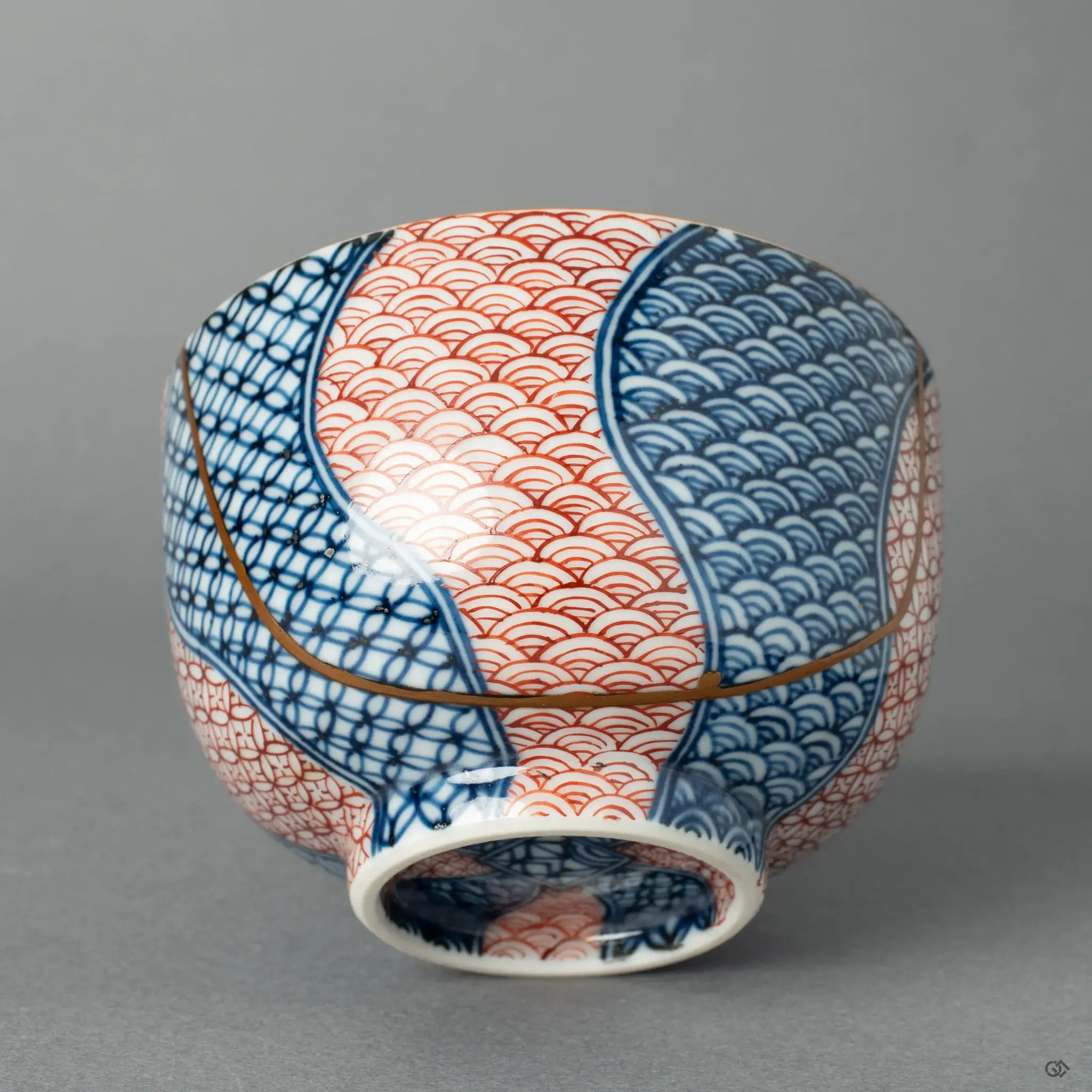 Master artisan examining a finished porcelain bowl in a sunlit workshop.