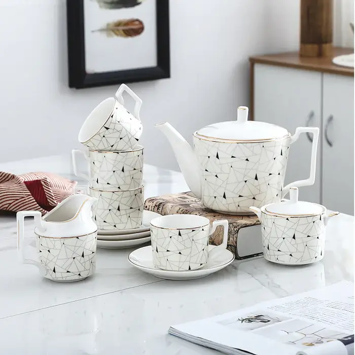 Modern matte black tea set with gold accents.