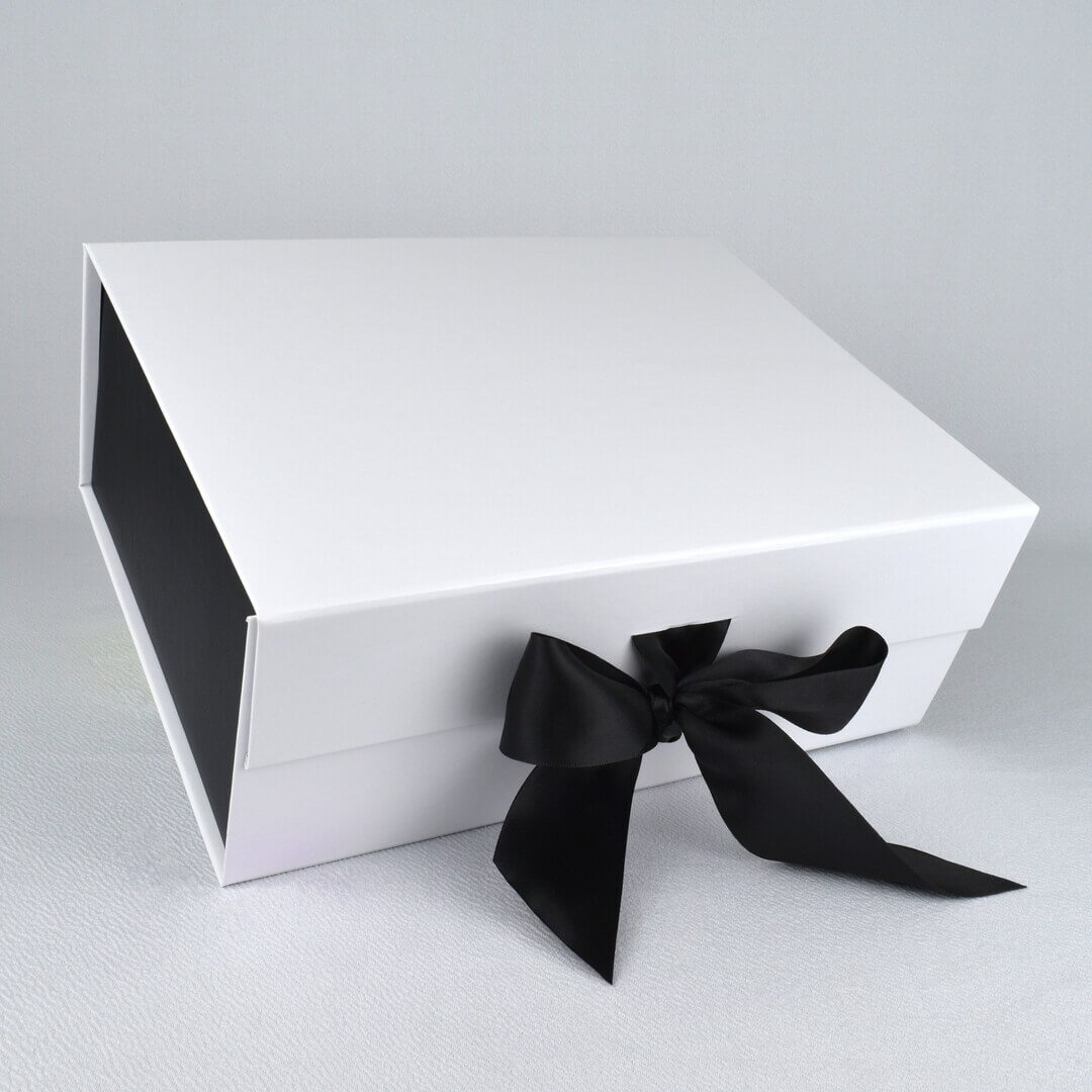 A bespoke gift box with a company's branding and a satin ribbon.
