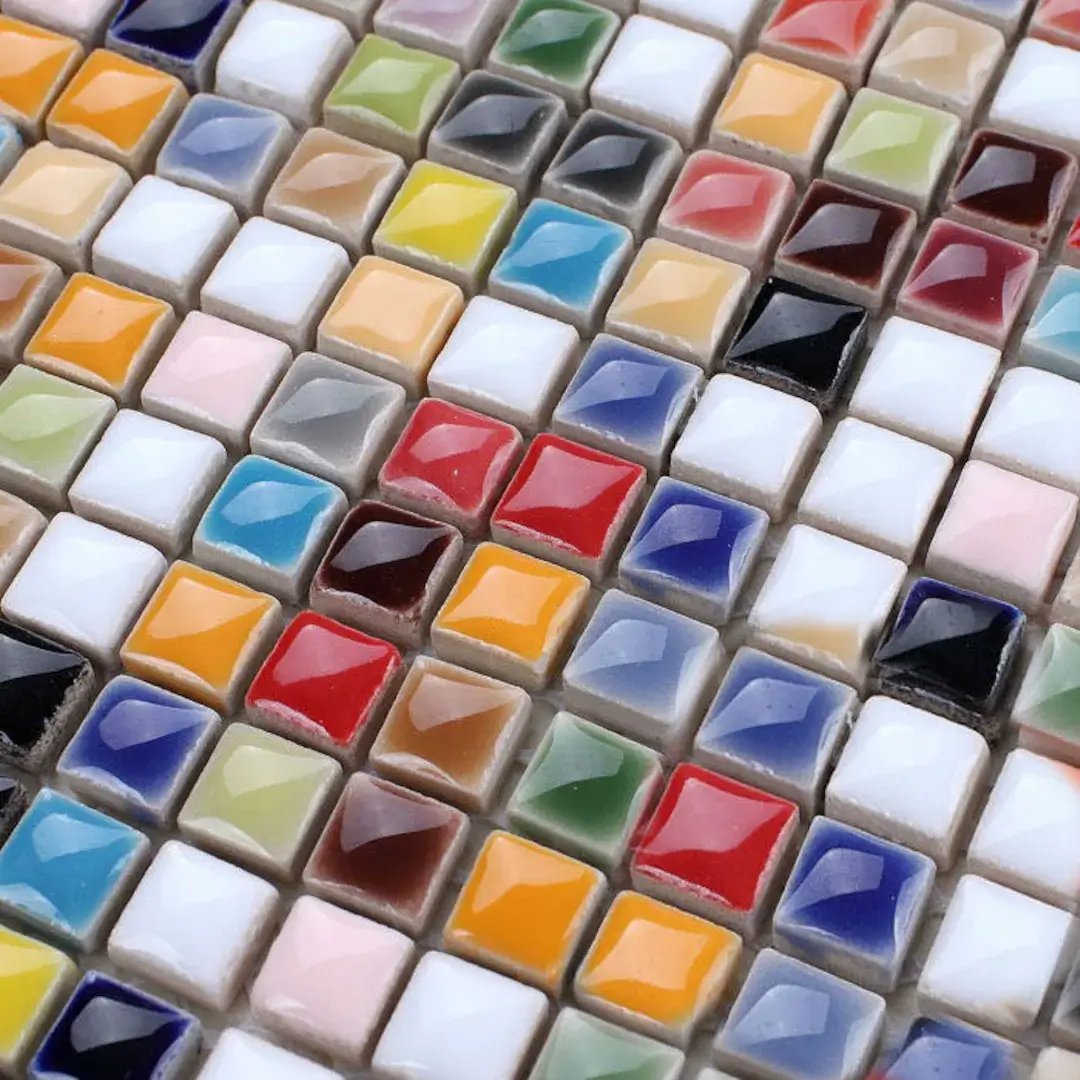 A collection of small, colorful glaze test tiles.